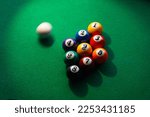Small photo of A miss shot. Near miss. Cue ball missing the opening break shot. A nine ball rack and a blurred cue ball on a billiard or pool table. shallow depth of field.