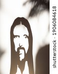 Small photo of Face of Jesus Crist in shadow on the wall, christian religion symbol