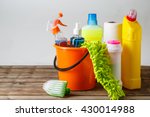 Bucket with cleaning items on light background