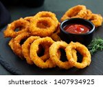 Homemade crunchy fried onion rings with tomato sauce 
