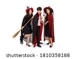Group of Asian man and woman wearing Halloween costume as witch and vampire Dracula, on white background, looking at camera
