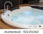 White round jacuzzi with swirling water in the bathroom