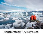 A young couple in glacier lagoon in Iceland.