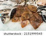 Small photo of Fresh flounder fish on crushed ice in showcase of fish shop
