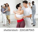 Caucasian man and lady rehearsing latin paired dance moves