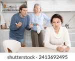 Small photo of Husband and senior mother-in-low clashed over financial question with woman. Family feuds, generational conflict, misunderstanding due to different views and opinions