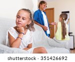 Small photo of Upset morose girl is jealous sister of stepbrother indoors