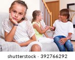 Small photo of Upset sad little girl is jealous sister of stepbrother indoors