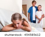 Small photo of Upset offended girl is jealous sister of stepbrother indoors