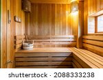 Small photo of interior of a classic Finnish sauna with a window and shelves made of natural wood