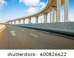 Empty road surface floor with city overpass viaduct bridge in sh