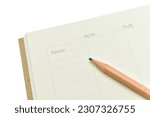 top view image of open planner notebook with blunt wood pencil isolated on white background