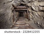 Small photo of Underground abandoned gold iron ore mine shaft tunnel gallery passage with wooden timbering