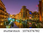 Night view of brick buildings alongside a water channel in the central Birmingham, England