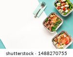 Healthy food delivery. Take away of organic daily meal on blue, copy space. Clean eating concept, healthy food, fitness nutrition take away in foil boxes, top view.