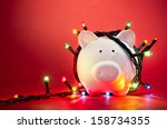 Piggy bank wrapped in Christmas string lights