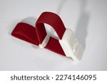 Small photo of A red tourniquet band on a white background