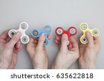 Hands holding popular fidget spinner toy
