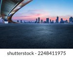 Asphalt road and bridge with city skyline in Shanghai at sunset, China. 