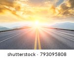 asphalt road and mountains with foggy nature landscape at sunset