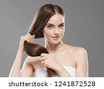 Smooth long brunette hair woman healthy and strong with healthy clean skin  female over gray background