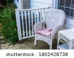 There Is A Wicker Chair With A...
