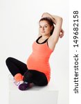 Small photo of regnant woman in sportswear