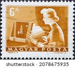 Small photo of HUNGARY - CIRCA 1972: A post stamp printed in Hungary showing a woman as a television writer with telex manual and teleprinter