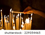 Woman Hand Lighting Candles  In ...