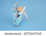 Small photo of Human brain on suitcase and airplane on blue background. Brain drain concept.