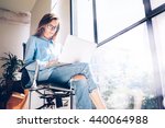 Hipster Girl use Laptop huge Loft Studio.Student Researching Process Work.Young Business Woman Working Creative Startup modern Office.Analyze market stock,new strategy.Blurred,film effect.Horizontal