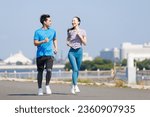 Young Asian adults jogging outdoors