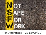 Business Acronym NSFW as NOT SAFE FOR WORK. Yellow paint line on the road against asphalt background. Conceptual image