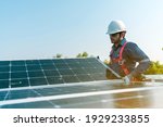 Small photo of A technician installing the solar panels at roof top of home and home office ,concept of economic energy and cost saving ,own small business