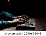Unknown person hands using a keyboard sends message with intimidating and threatening to the interlocutor
