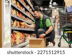 Small photo of A stock clerk is arranging products on shelves at the supermarket.
