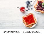 Delicious toasts with sweet jams on wooden background