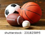 Sports balls on wooden...