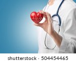 Cardiologist holding red heart with electrocardiogram. Cardiology concept.