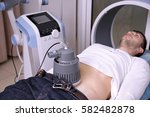 Small photo of Inductive shortwave diathermy for young man in modern clinic