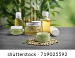 Hemp cosmetic products and seeds on grey background