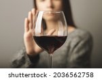 Small photo of reject liquor,stop alcohol, teenager girl shows a sign of refusal of wine