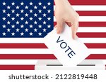 Small photo of voting in the usa, a hand with a ballot against the background of the american flag puts the vote in the ballot box, congressional elections, the senate of political parties