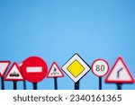 Small photo of traffic rules and guidelines for drivers, driving safety and education, road signs on a blue background