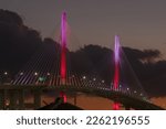 Small photo of New Gerald Desmond Bridge, looking west, shown at dusk in the Port of Long Beach, California. The red, pink, and white color scheme is chosen to celebrate St. Valentine's Day.