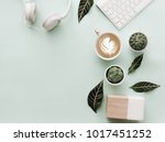 Blogger Pastel Background With Coffee Cup, Headphones and botanical elements. Flat Lay 