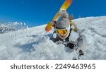 Small photo of CLOSE UP: Young woman sliding through soft snow after she falls at snowboarding. Female beginner snowboarder is sliding face forward after falling down on a snowy ski slope at mountain ski resort.