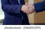 Businessman in suit greet on street with gesture of male hands. Businessmen shaking hands, teamwork. Close-up. Two men shaking hands, making successful contract agreement, partnership cooperation.