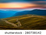 Transalpina road. Transalpina is one of the highest roads passing the Carpathians in Romania. Layers of haze cover the mountains peaks at sunset.