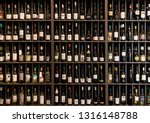Collection of wines in the store of elite alcohol. Bottles of various wines are beautifully on the rack. Paint effect.